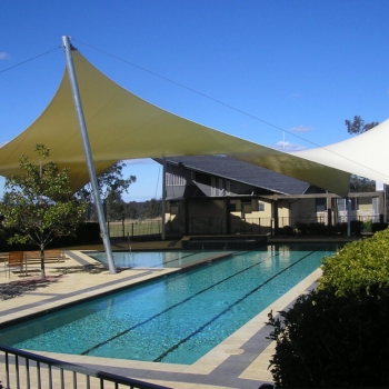 Sun shade structure covering pool area and playground equipment by Shade to Order, Newcastle, Sydney