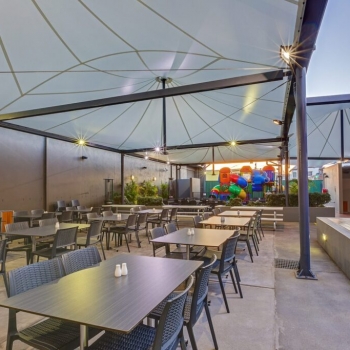 Waterproof shade structure for outdoor dining area designed by Shade To Order, Newcastle, Sydney